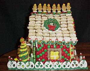 Leah did most of this side. Notice the m&m patterns and the wonderful wreath. The wreath is a decorated dried apple. Sabrina added the wonderful roof topping of teddy grahams.
