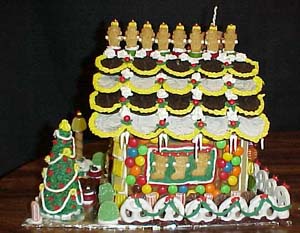 Sabrina created the wonderful bay window with stocking hung in it. Julie went crazy with icing on the roof!