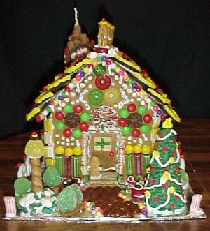 Janelle beautifully decorated the front of this house. Notice the detail on the door and the wreath above it. Julie decorated the tree. Myra did the lamppost.