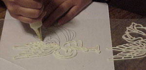 Tracing a pattern in icing made a delicate angel.