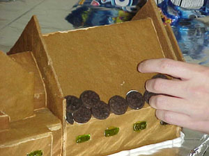 Next we placed it on its wooden platform (which we also built), and started to do the shingling. In this case, mini-oreos were perfect.