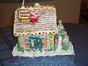 This side started with too runny icing and the blue m&ms for the window sagging down. But doesn't it look great now! Everything is fixable with some icing and candy!! Don't you love the fence?