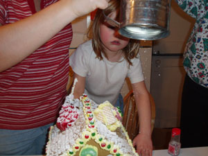 Putting on the finishing touches: making it snow with powdered sugar!