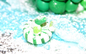 In the water is a frog on a lily pad.