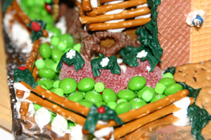 A close up of the red bushes with green leaves and snowflake topping! Notice also the grass made of green skittles and other green candy.