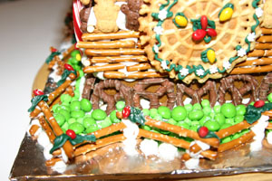 A view from the back of the church. Noticed the walls - a row of chocolate pretzels, topped by straight pretzels, with two rows of teddy grahams to finish the wall decoration. Finally a wreath window to top it off.
