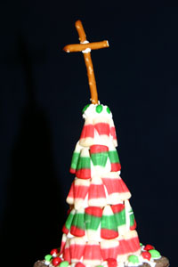 The steeple was decorated with two kinds of Christmas candy corn. The cross at the top was held up with wrapped parchment paper until it solidified.