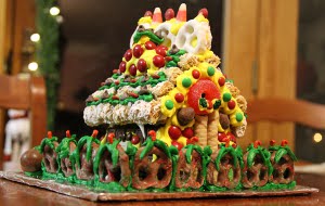 The back of Janine's house. Notice the sagging gable. Icing wasn't quite hard enough. At first I thought it was the warmth of the house where we had the party, but later learned from our expert, Julie, that it was probably that we didn't beat the icing long enough.