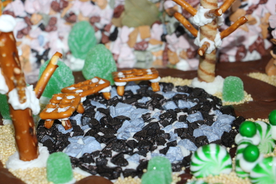 Chocolate rock circle, pretzel stick tree and some bushes.