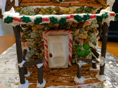 A closeup of the front door. That's made of white icing shaped into what looks like a store-bought door!