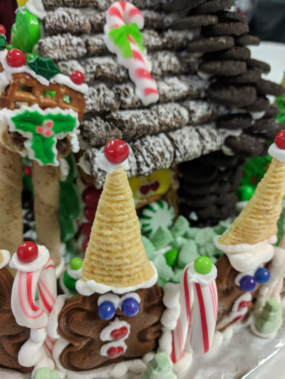 A fence made of little decorated gingerbread men and candy canes.